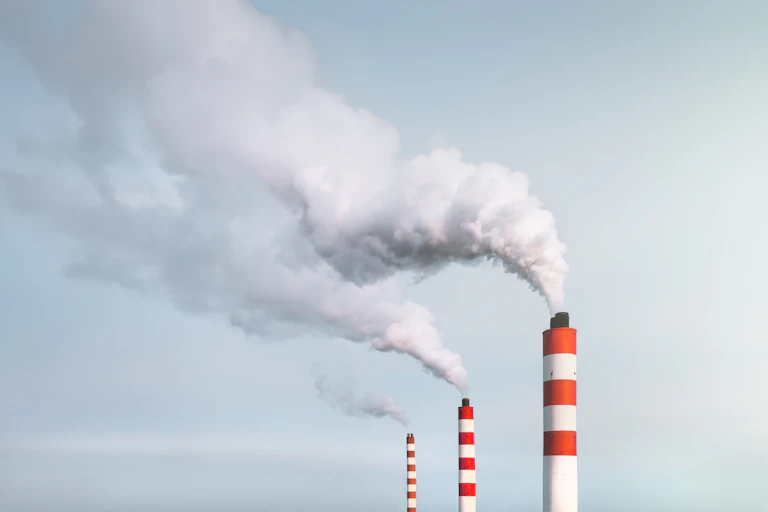 Chimneys releasing exhaust into the sky