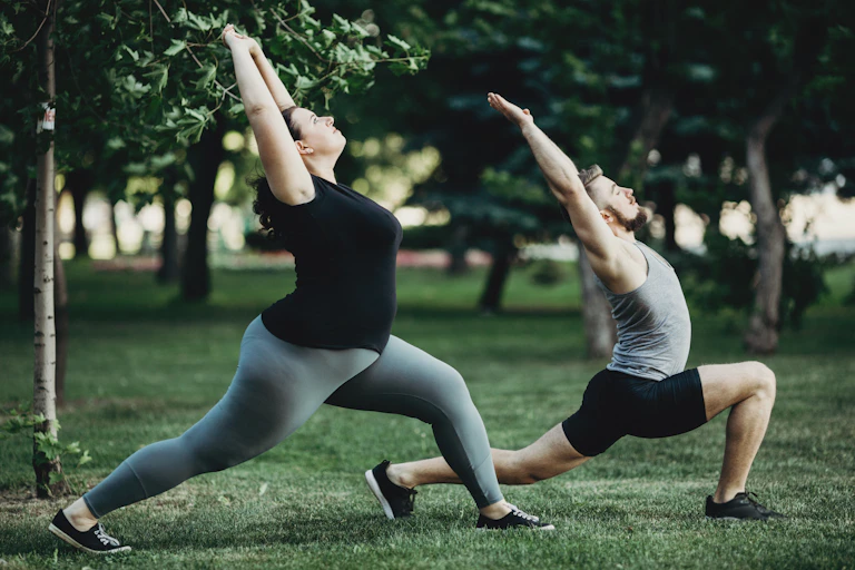 People doing yoga in the park