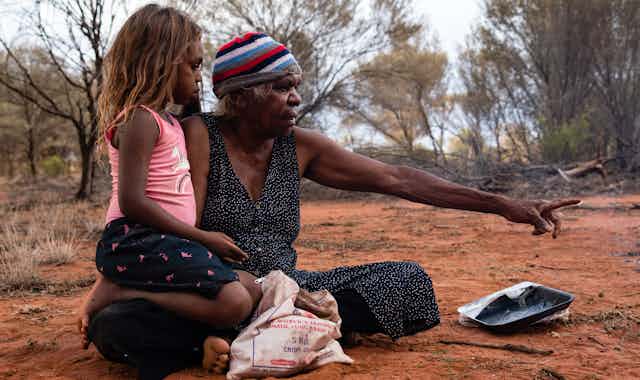 Yuendumu, NTFebruary 15 2020. An Aboriginal Grandmother and granddaughter, after hunting honey ants.