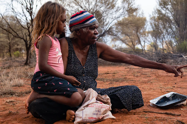 Yuendumu, NTFebruary 15 2020. An Aboriginal Grandmother and granddaughter, after hunting honey ants.