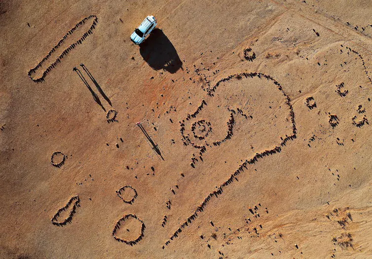 a pattern of stones forming pictures, as seen from the air