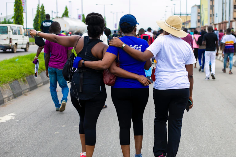 The back view of a group of women who are wearing fitness attire and participating in a walk.