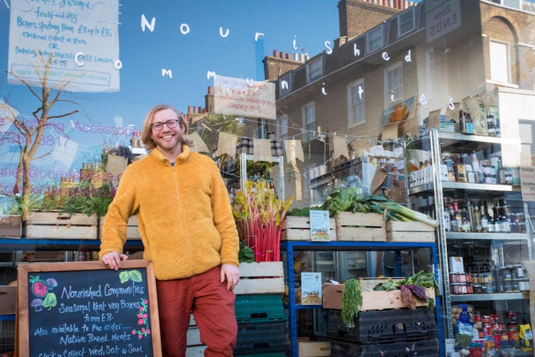 A person stands outside a farm food shop