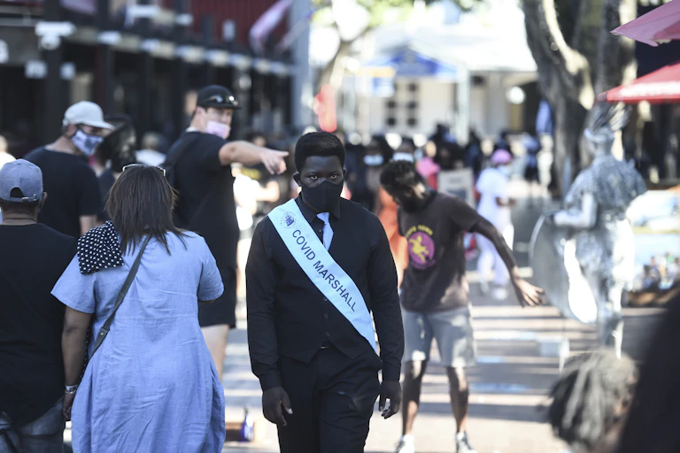 man wearing a sash and face mask