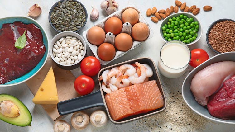 Variety of zinc-rich foods laid out on a white table