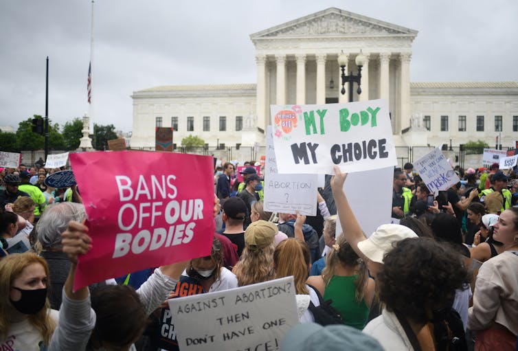 Protesters holding signs like