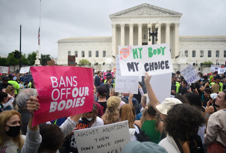 Protesters holding signs like 