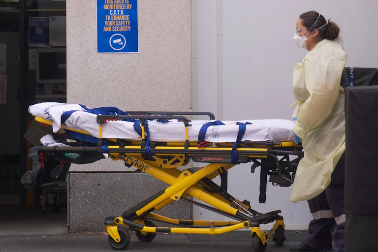 Paramedic pushes a stretcher