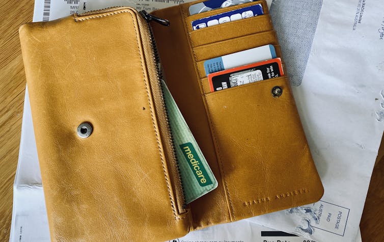 wallet with medicare card and bills