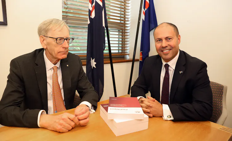 Banking royal commissioner Kenneth Haynes hands his report to Treasurer Josh Frydenberg.