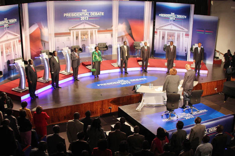 Eight people standing on stage.