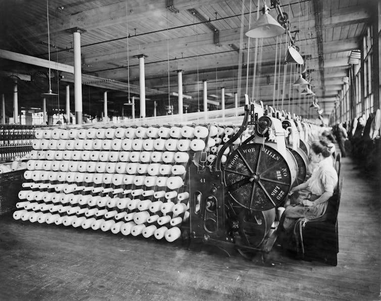 A series of textile machines with women working at them