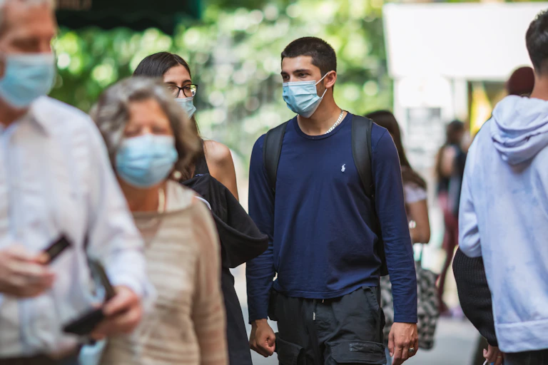People walking wearing masks.