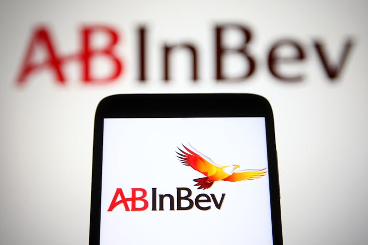AB InBev logo behind a smartphone also showing the logo