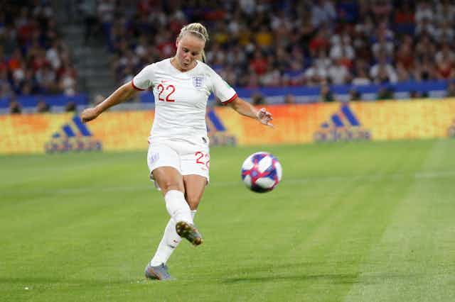 A female England footballer called Beth Mead wearing. the number 22 shirt