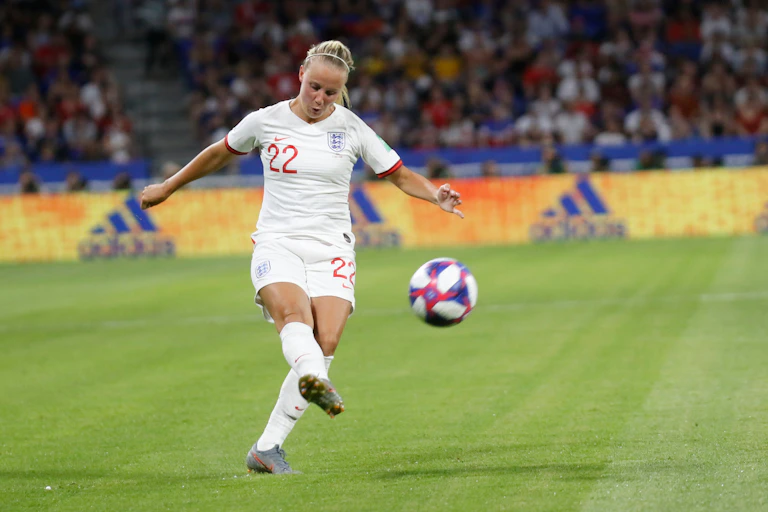 A female England footballer called Beth Mead wearing. the number 22 shirt