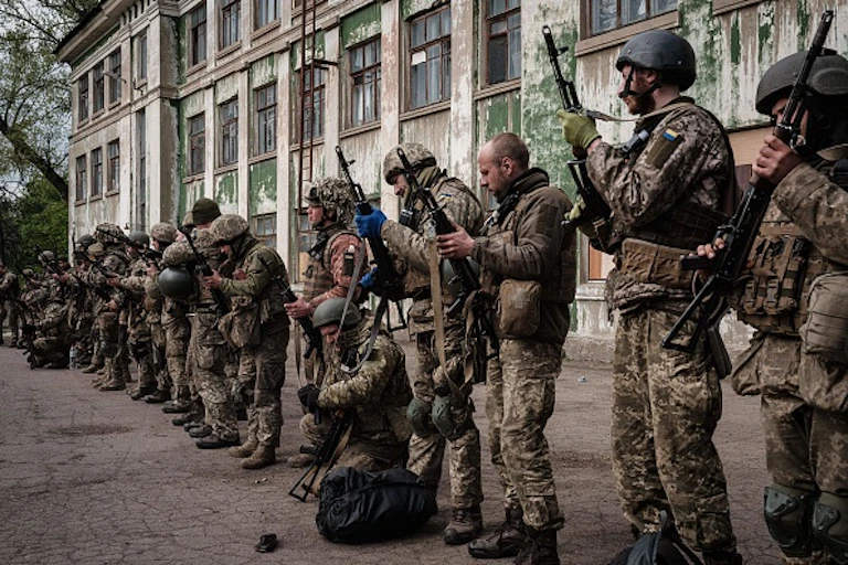 Men in a straight line holding guns