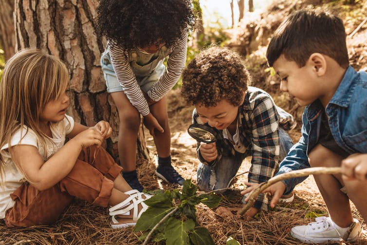 Four children play in nature