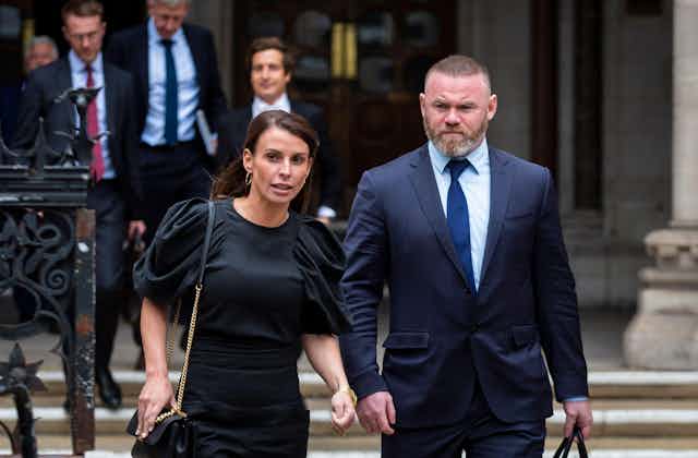 Coleen Rooney and Wayne Rooney walk away from the high court