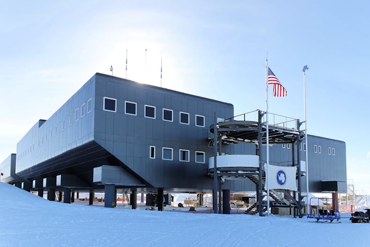 A large silver building on a snowy landscape.