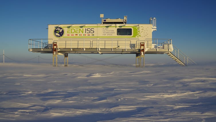 A white building above a frozen landscape.