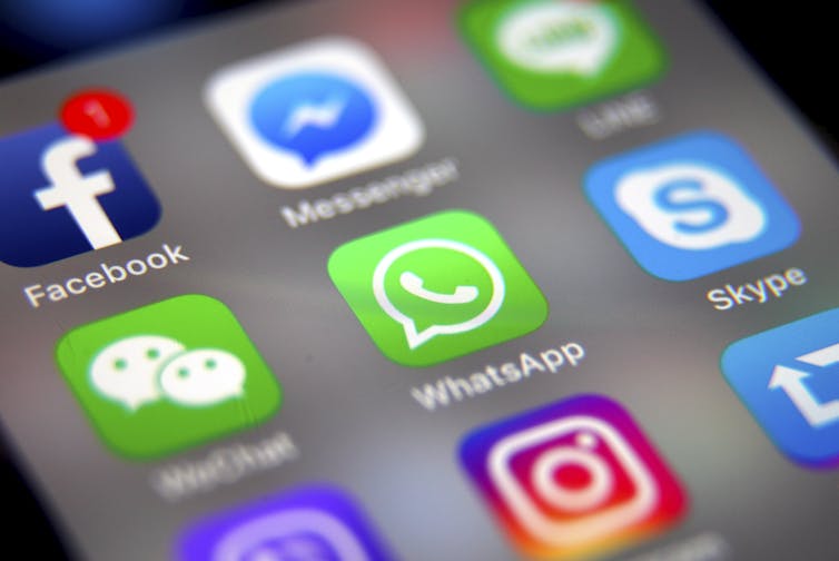 A phone screen showing social media apps like Facebook, WhatsApp, Instagram etc.