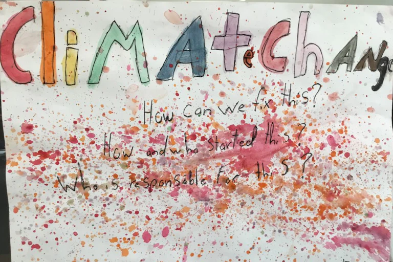 Painted poster of primary school students' questions about climate change