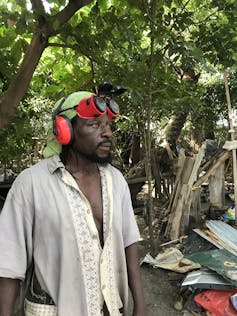 Man standing with goggles on his head and a shirt