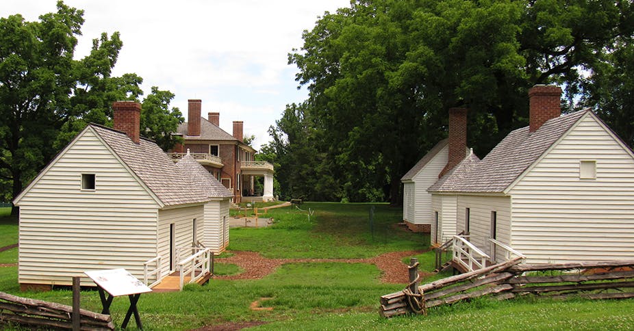 Small whitewashed slave cabins with Madison's home in the background