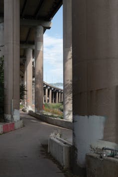 Giant concrete columns support the overhead traffic lanes of the junction