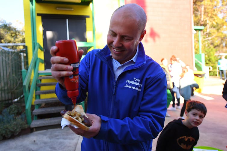 Treasurer Josh Fydenberg adds sauce after voting in Kooyong