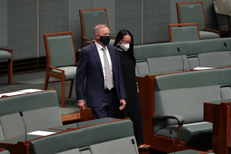 Anthony Albanese and Linday Burney walk together through parliament.