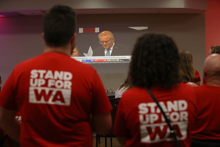 Labor supporters in WA watch outgoing Prime Minister Scott Morrison concede on election night.