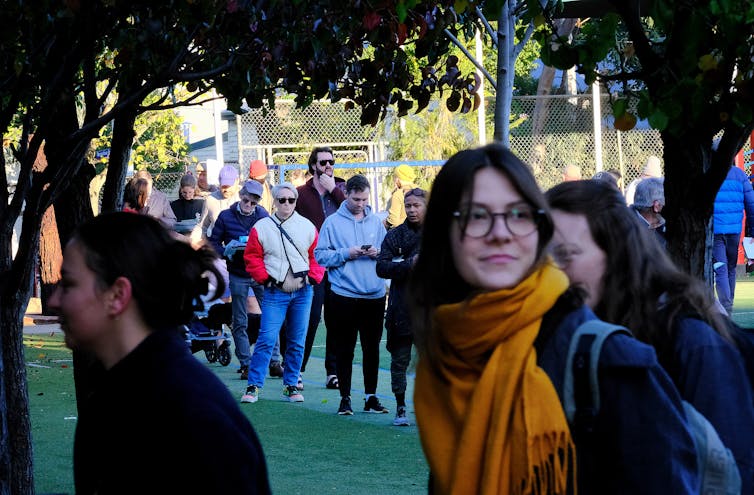A young women lines up to vote in the seat of Melbourne.