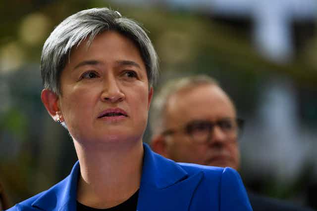 Penny Wong and Anthony Albanese in background.