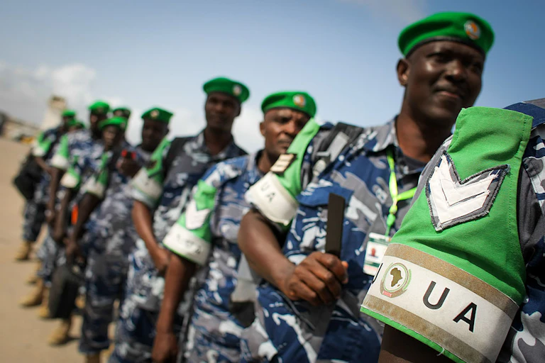 Men in police uniform are lined up in a row.
