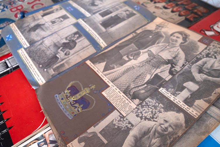 A page from a coronation scrapbook featuring black and white photos of the young Queen and her children.