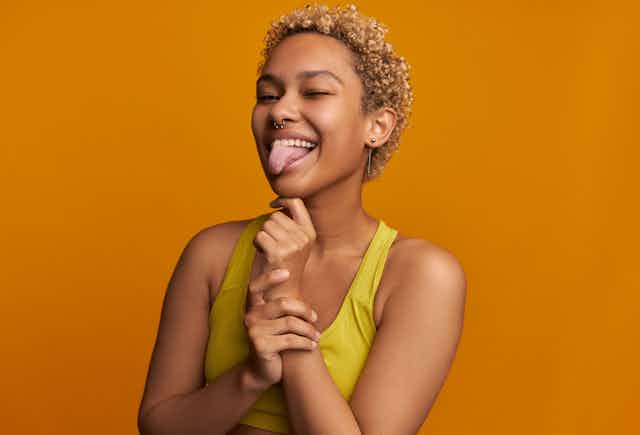 Woman sticking her tongue out and smiling.