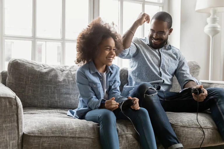 Father and daughter playing video game