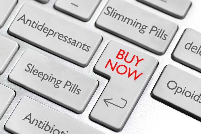 A keyboard display with keys that say the names of common types of drugs such as antidepressants and sleeping pills, alongside a key that says "Buy Now" in red font.