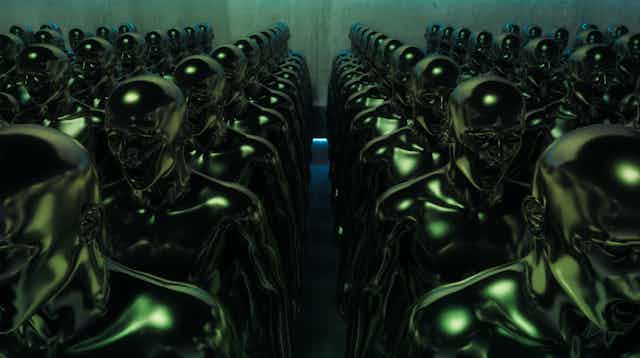 a computer-generated image of rows of identical metallic humanoid robots