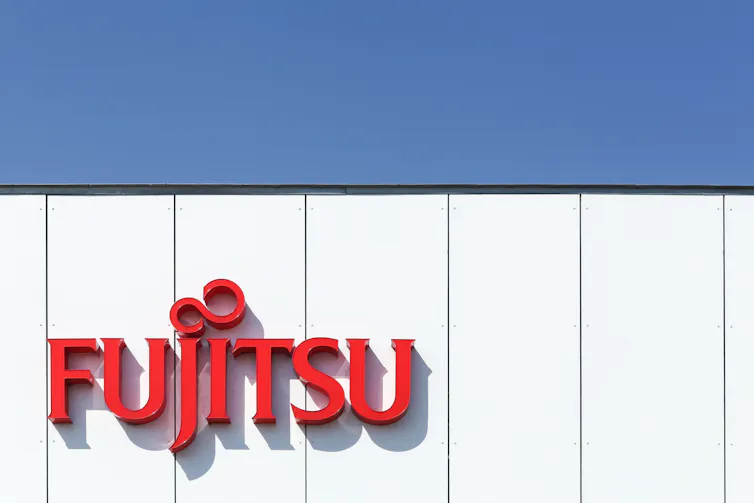 The 'Fujitsu' logo in red is displayed on a building's side