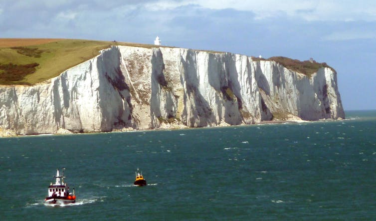 Photographs showing white cliffs rising from the sea.