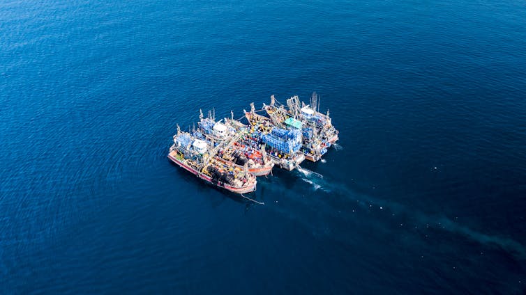 Aerial view of fishing trawlers in the ocean.