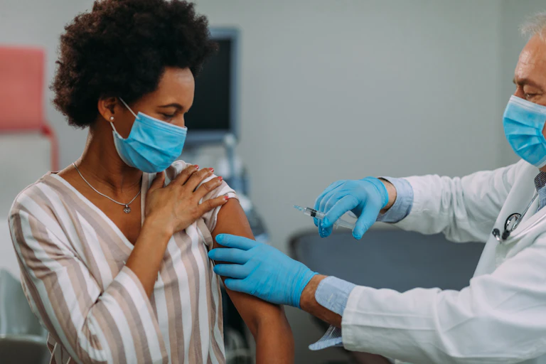 A woman receives a vaccination.