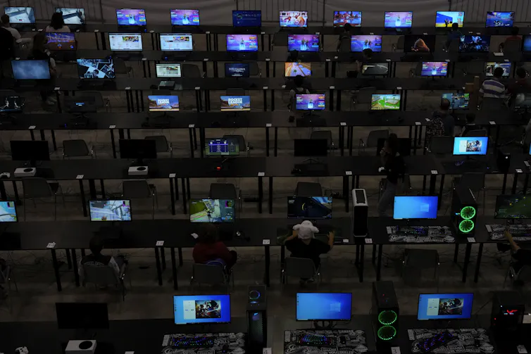 Children play video games at Romics fair in Rome, an international festival of comics, animation, cinema and games.
