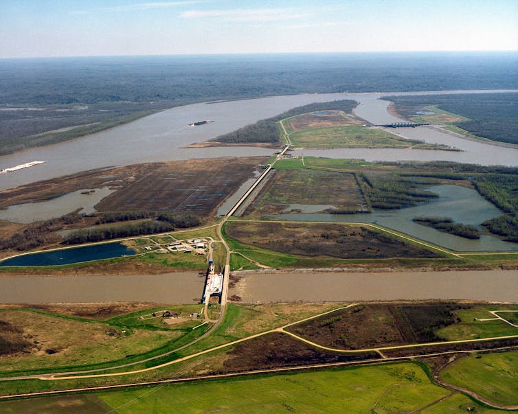 Two rivers converge with dams separating them.