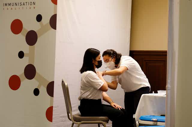 health worker gives woman an injection