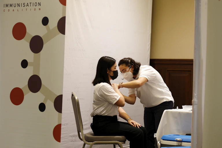 health worker gives woman an injection
