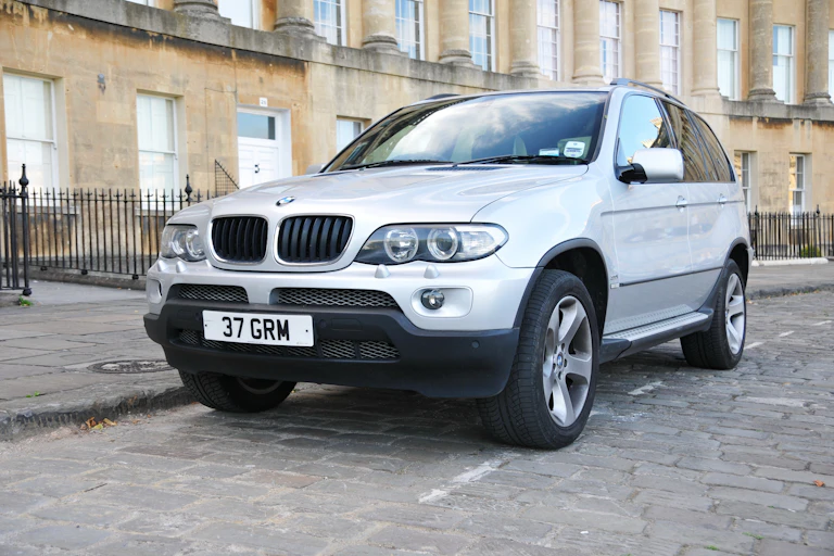 Large car parked in front of Georgian buildings